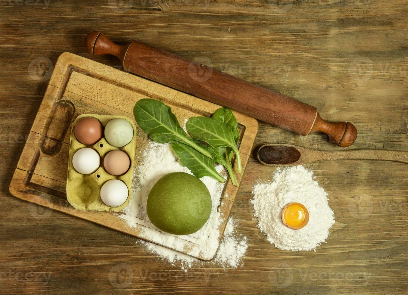 Green noodle dough bun, with ingredients on the table. photo