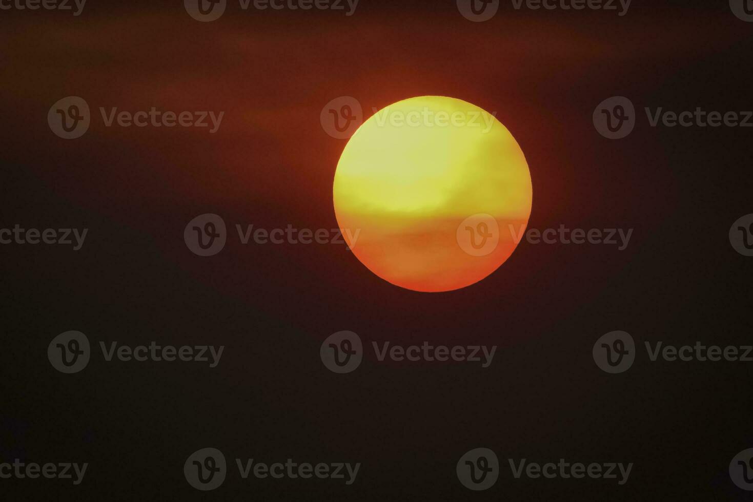 Orange sunset with clouds, in Pampas province, Argentina photo