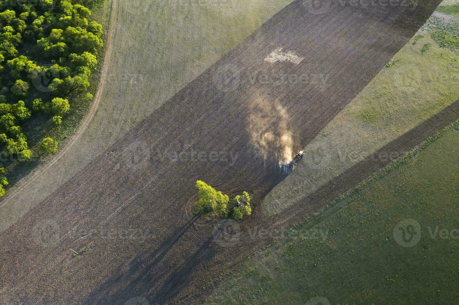 Tractor plowing the field, Pampas countryside, La Pampa, Argentina. photo