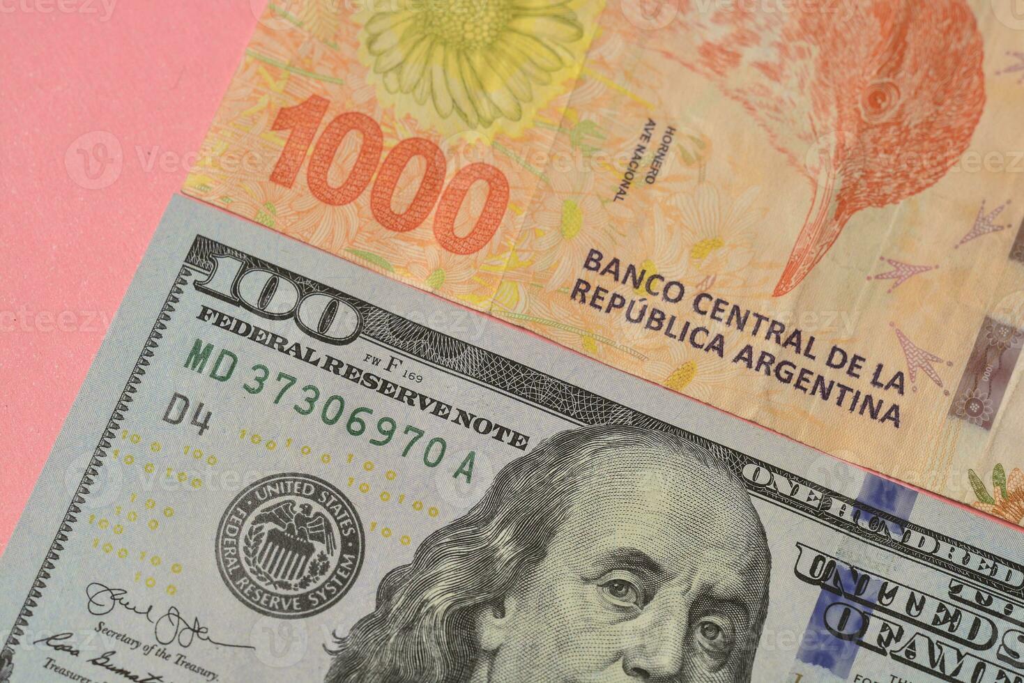 New Argentine banknotes and US dollar bills photo