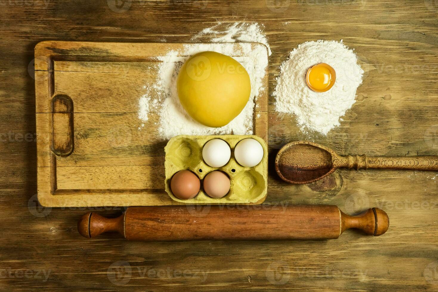 Egg dough for noodles, with ingredients on the table. photo