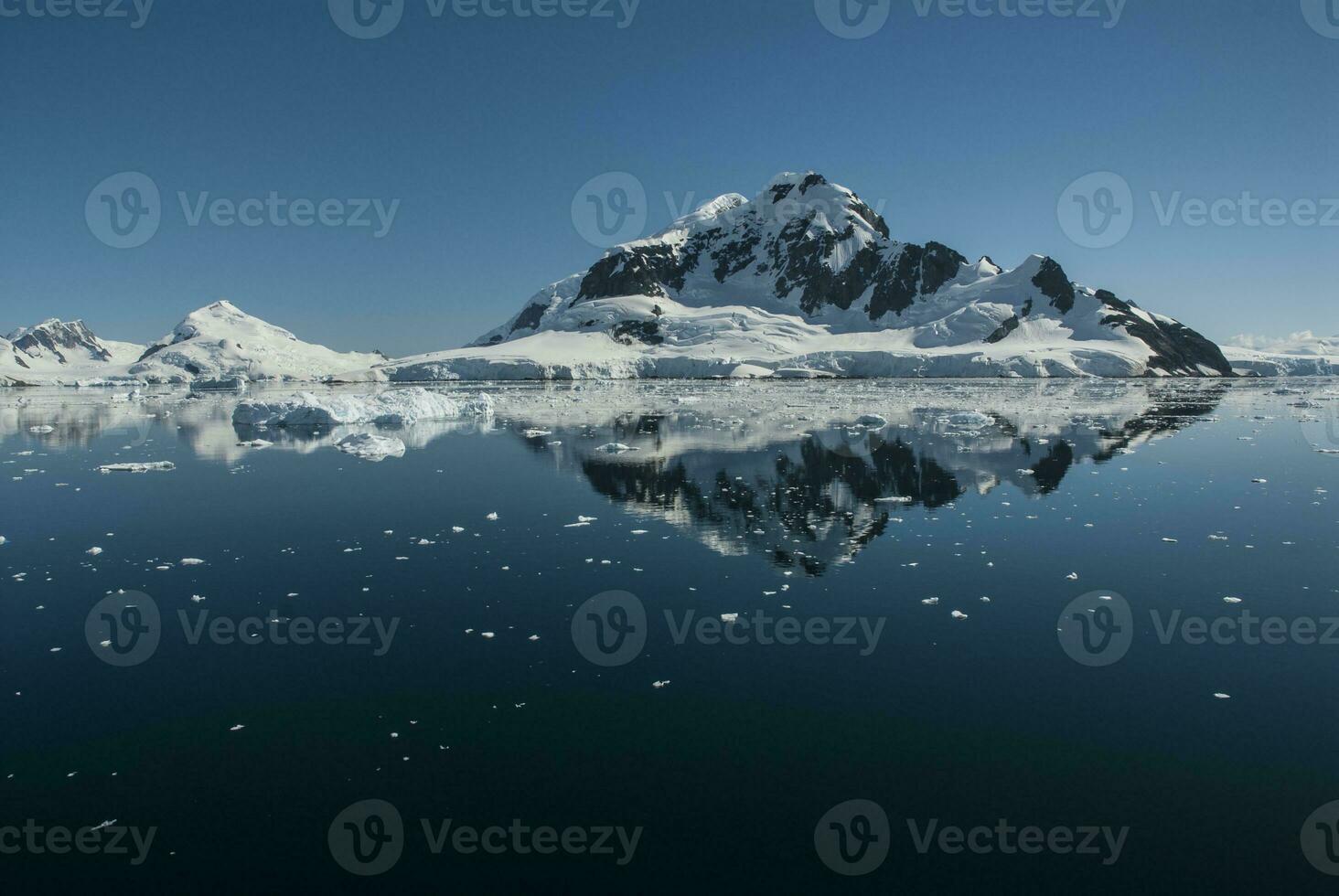 Lemaire strait coast, mountains and icebergs, Antartica photo