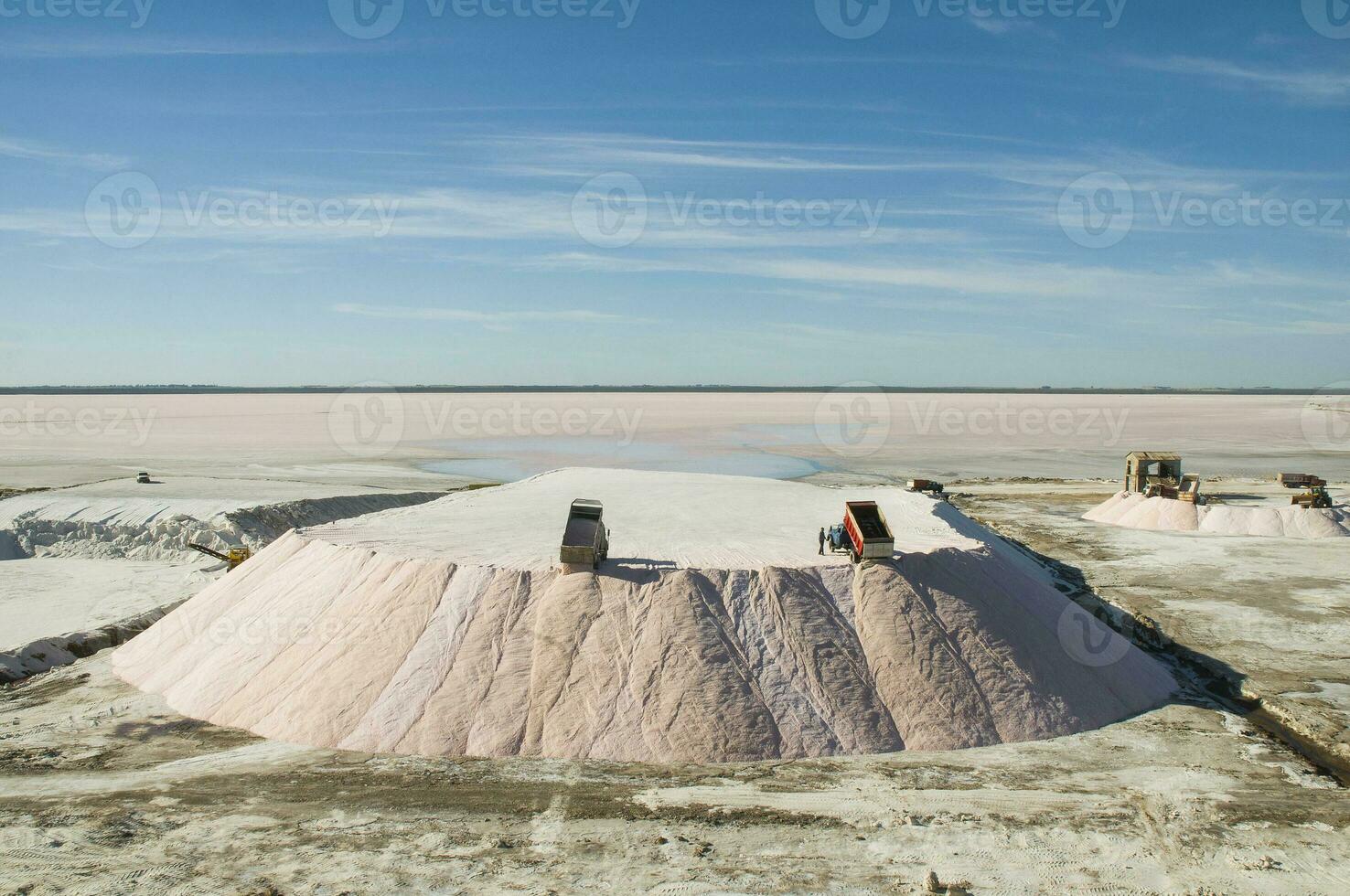 Trucks unloading raw salt bulk, Salinas Grandes de Hidalgo, La Pampa, Argentina. photo