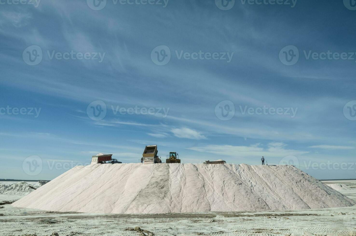 Trucks unloading raw salt bulk, Salinas Grandes de Hidalgo, La Pampa, Argentina. photo