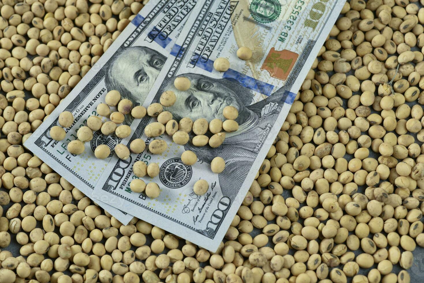 Dollars banknotes and coins and soy beans,oleaginous commoditi value concept. photo
