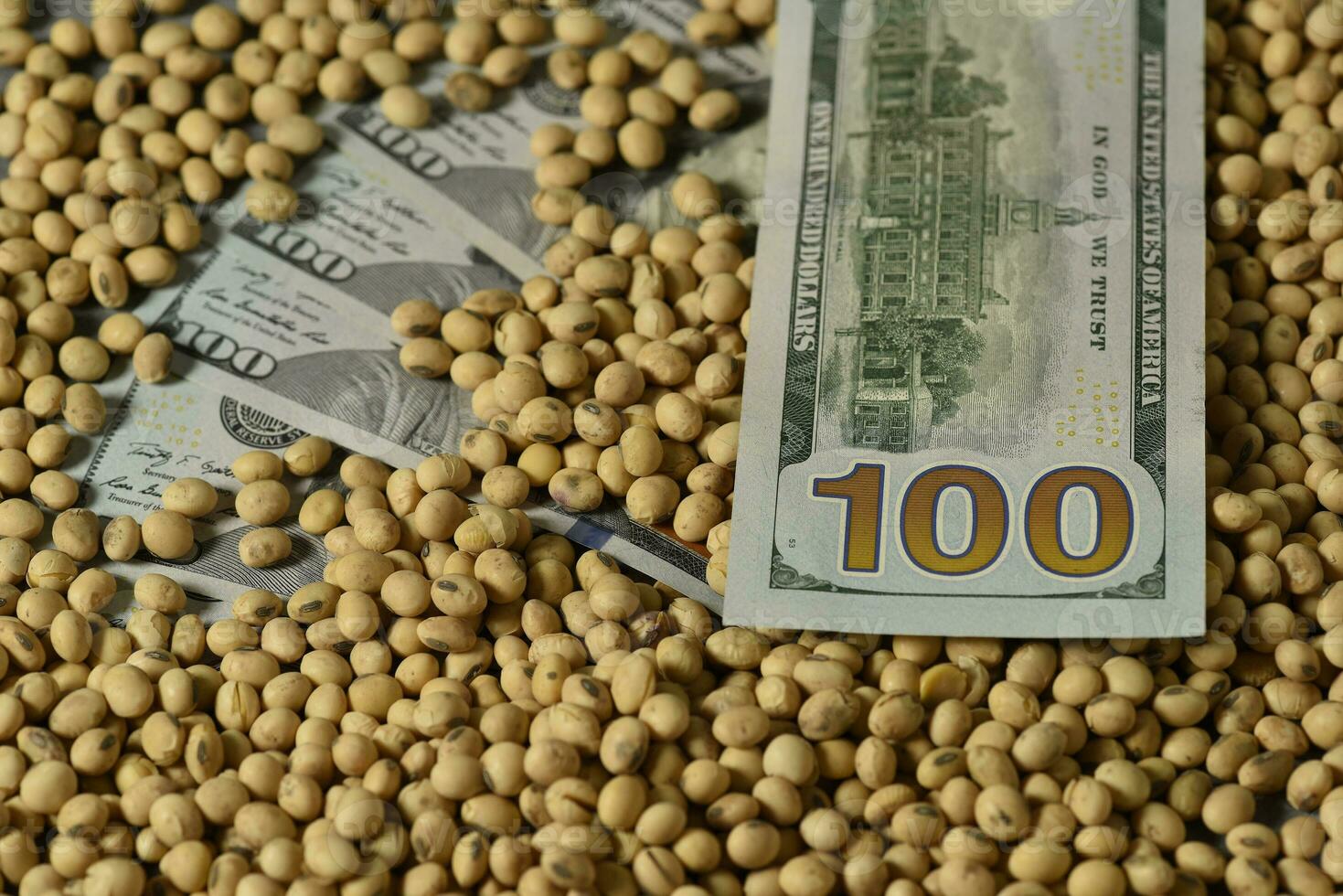 Dollars banknotes and coins and soy beans, commoditi value concept. photo