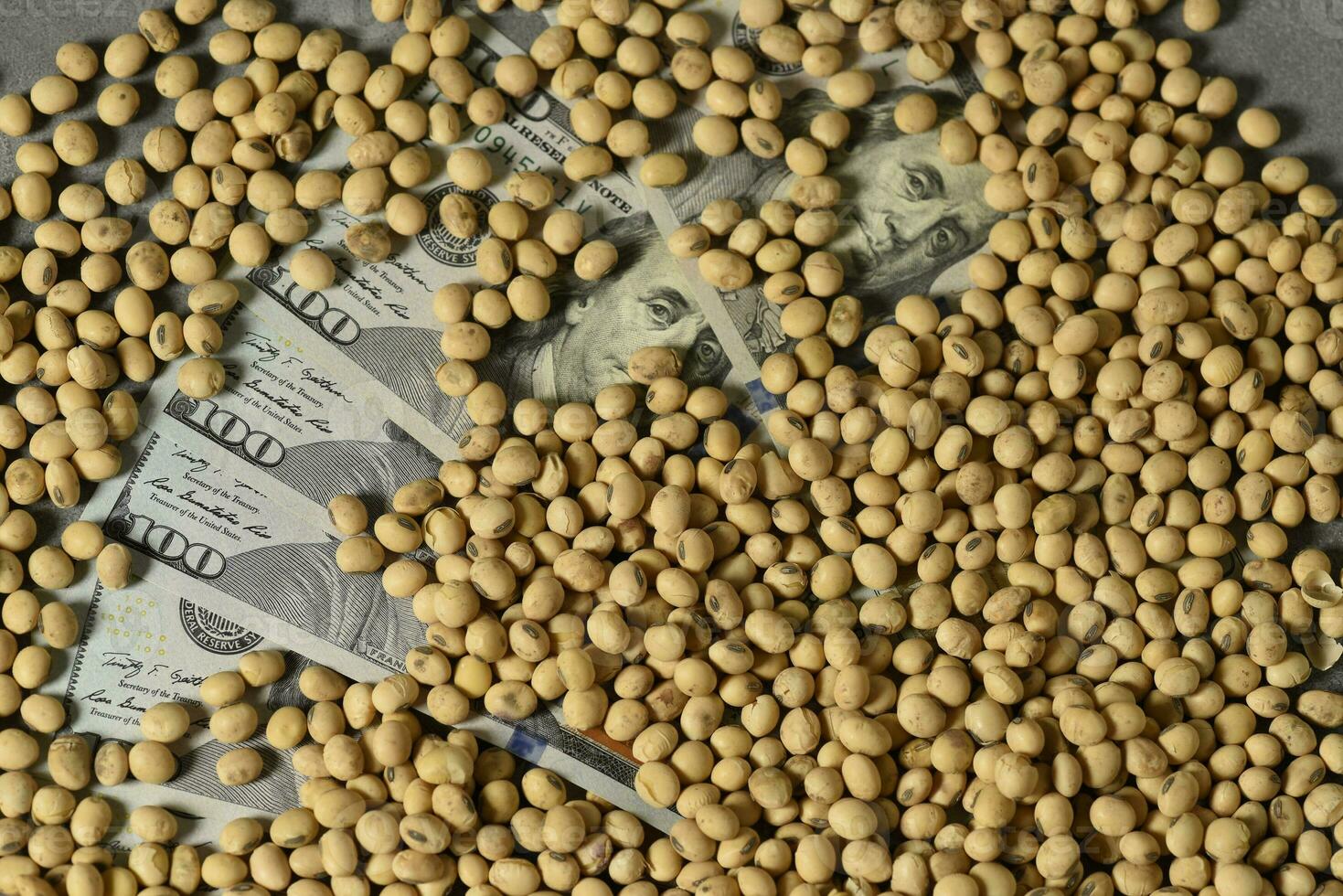 Dollars banknotes and coins and soy beans,oleaginous commoditi value concept. photo