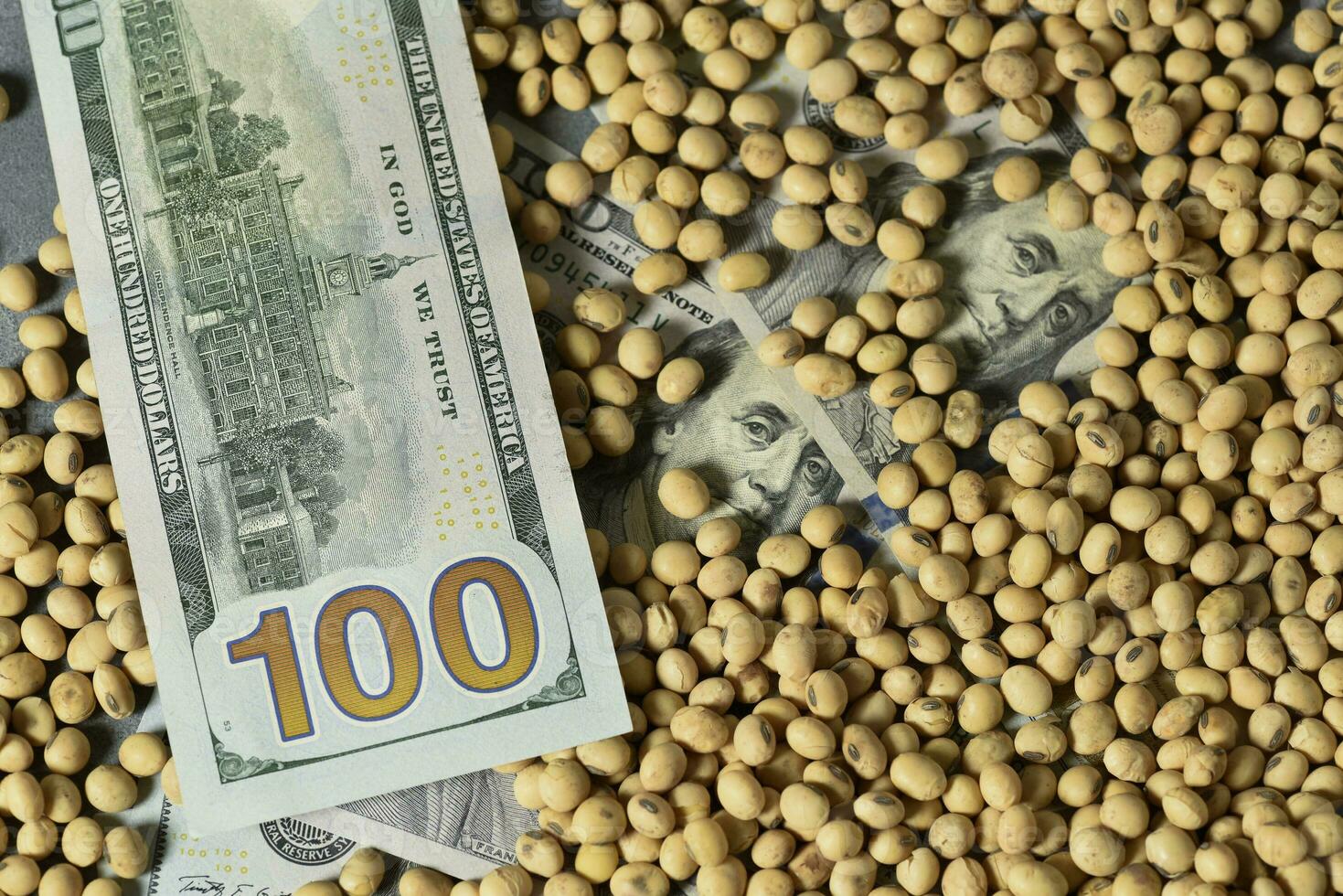 Dollars banknotes and coins and soy beans,oleaginous commoditi value concept. photo