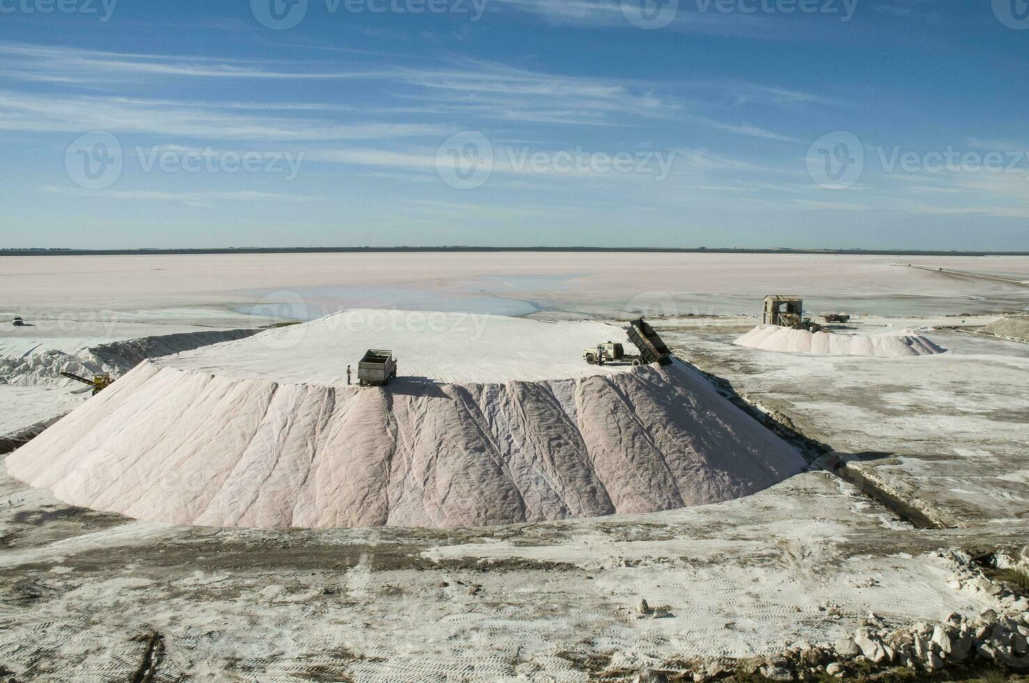 Trucks unloading raw salt bulk, Salinas Grandes de Hidalgo, La Pampa, Argentina. photo