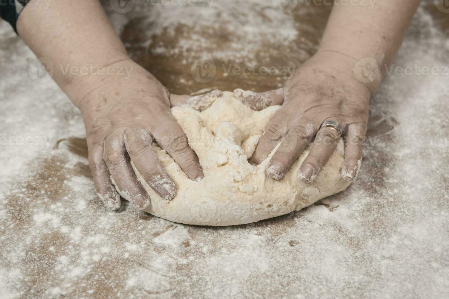 Hands kneading dough for gnocchi. photo