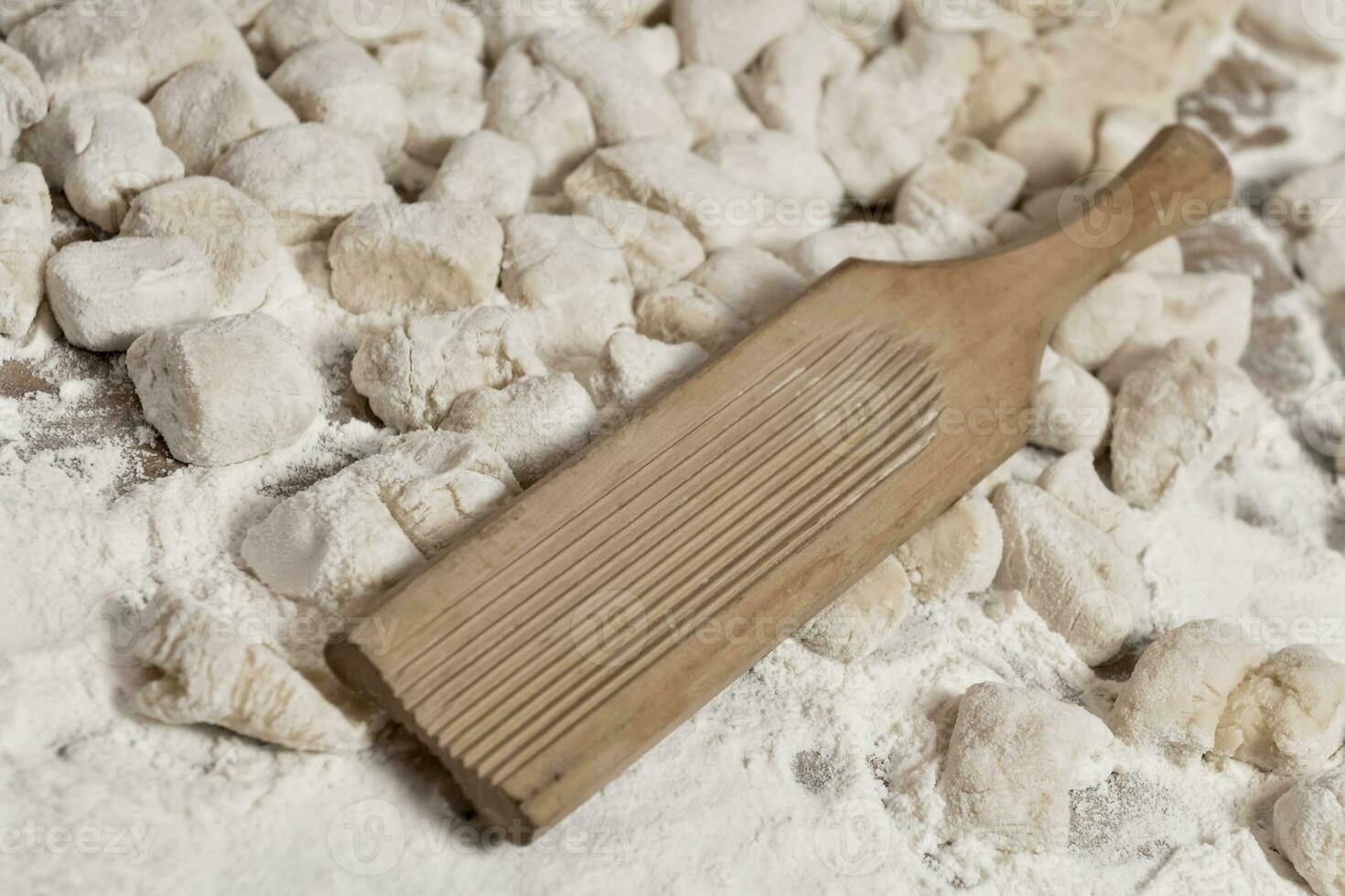 Dough of handmade gnocchi and cooking elements photo