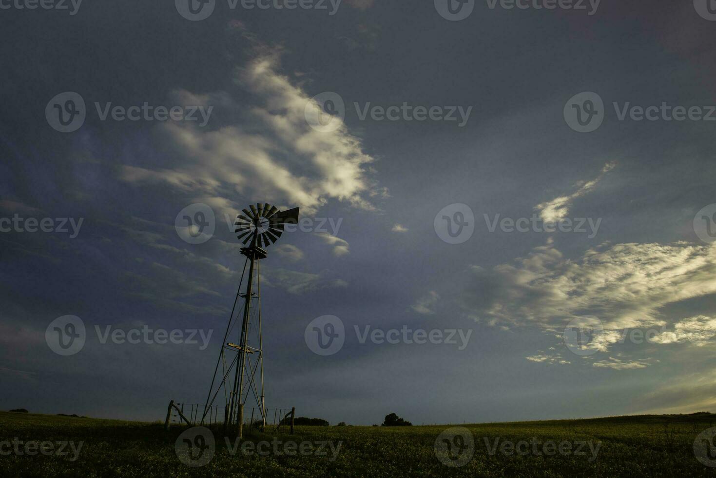 Windmill in countryside at sunset, Pampas, Patagonia,Argentina. photo