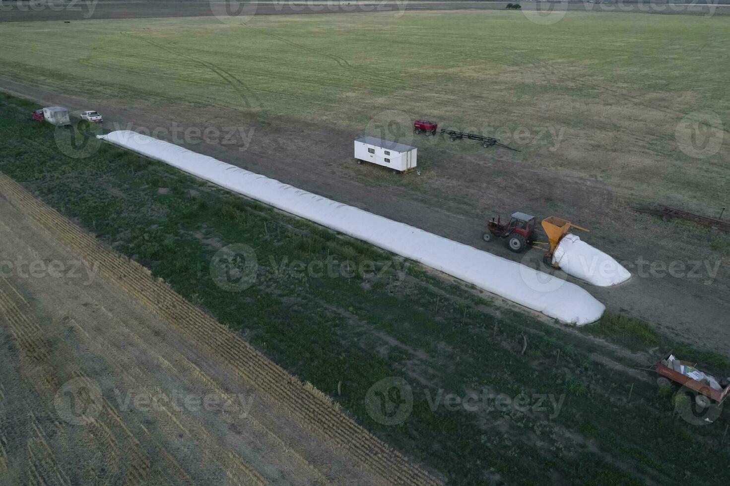 Silo bag work in pampas countryside, grain storage in La Pampa, Argentina photo