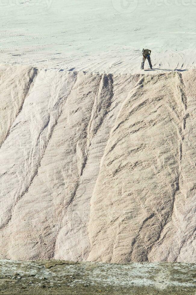 Trucks unloading raw salt bulk, Salinas Grandes de Hidalgo, La Pampa, Argentina. photo