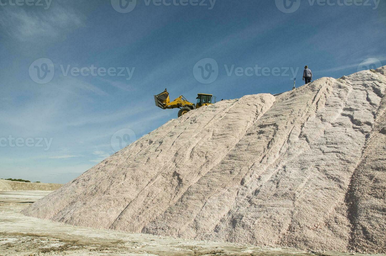 Trucks unloading raw salt bulk, Salinas Grandes de Hidalgo, La Pampa, Argentina. photo