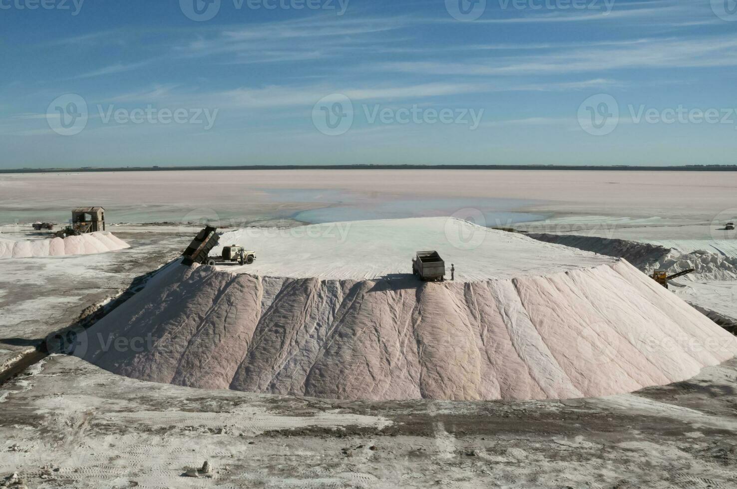 Trucks unloading raw salt bulk, Salinas Grandes de Hidalgo, La Pampa, Argentina. photo