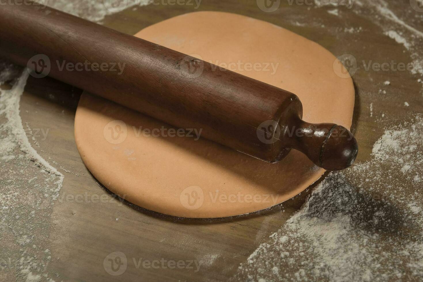 Egg dough for noodles, with ingredients on the table, traditional italian cuisine. photo