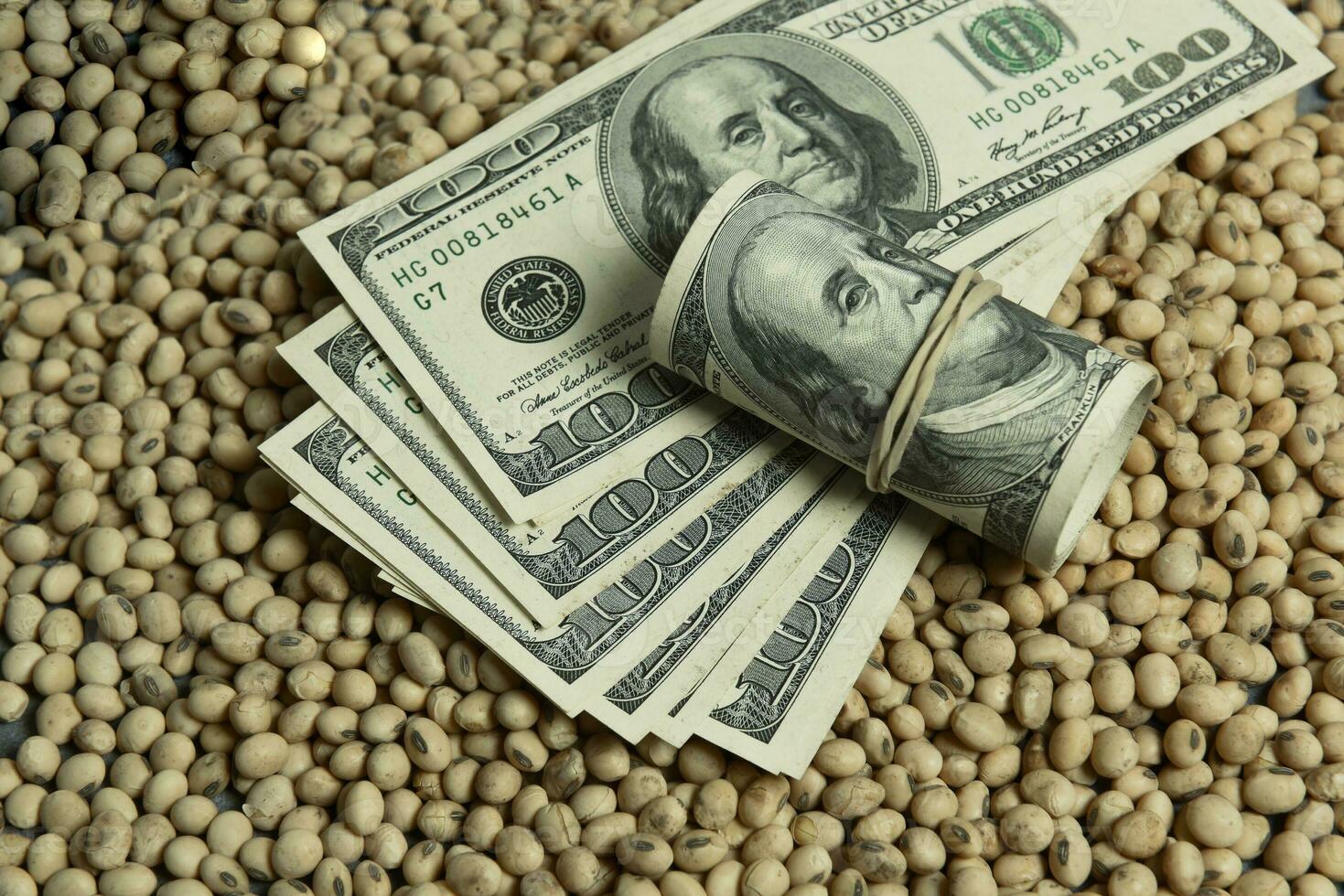 Dollars banknotes and coins and soy beans,oleaginous commoditi value concept. photo