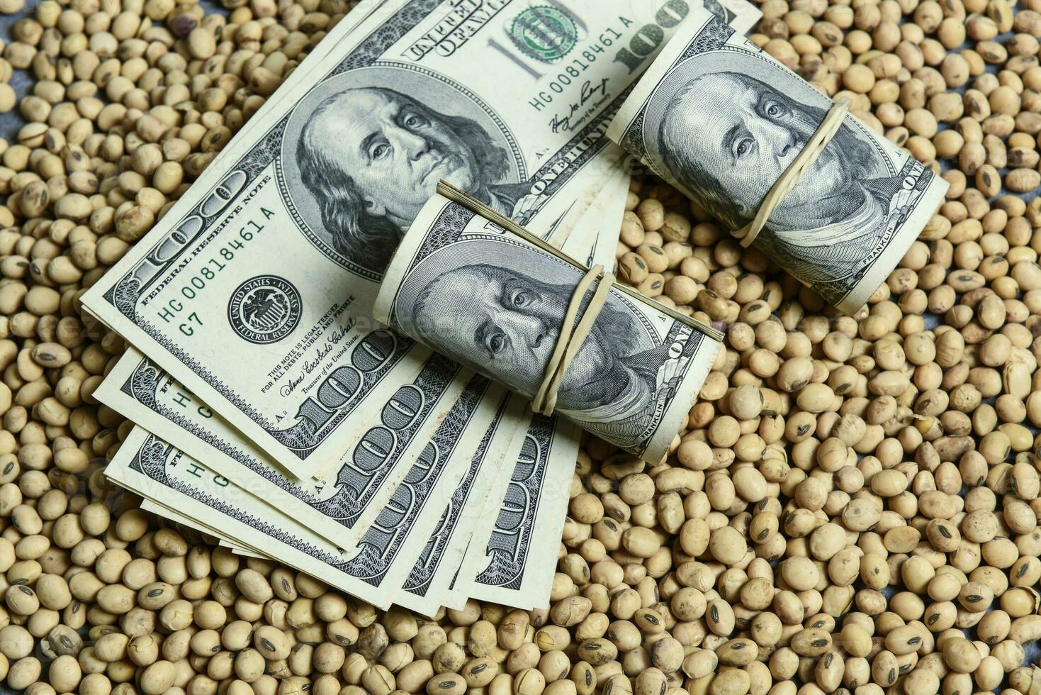 Dollars banknotes and coins and soy beans,oleaginous commoditi value concept. photo