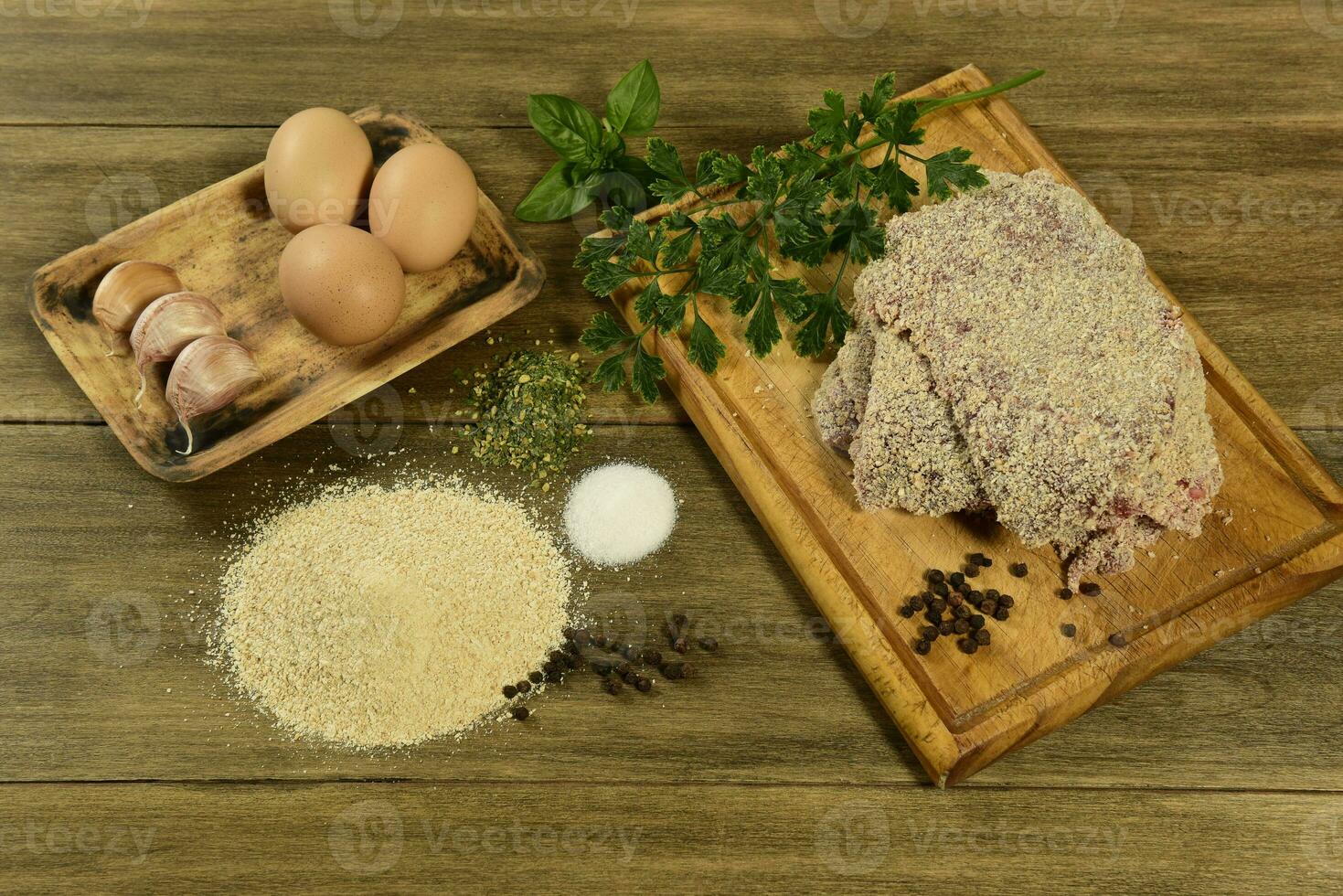 Veal milanese presented on the table with ingredients photo