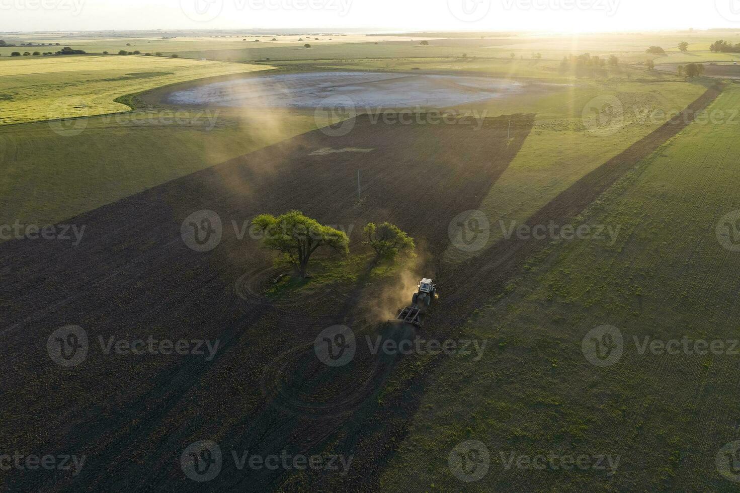 Tractor and agricultural machinery sowing, La Pampa province, Patagonia, Argentina. photo