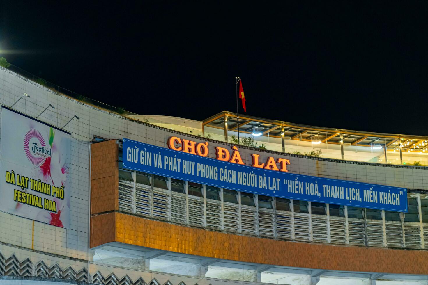 Da Lat, Viet Nam - 3 June 2023 Da Lat Market night skyline night view with lights attracts thousands of people walking along the road shopping photo