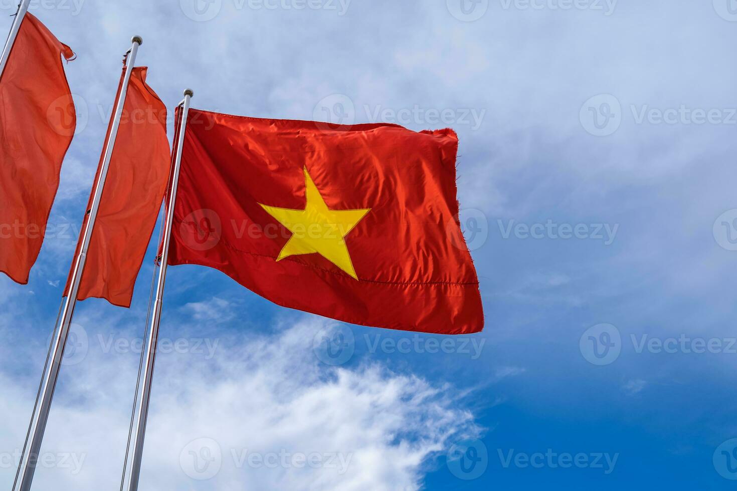 Vietnam flag isolated on the blue sky with clipping path. close up waving flag of Vietnam. photo