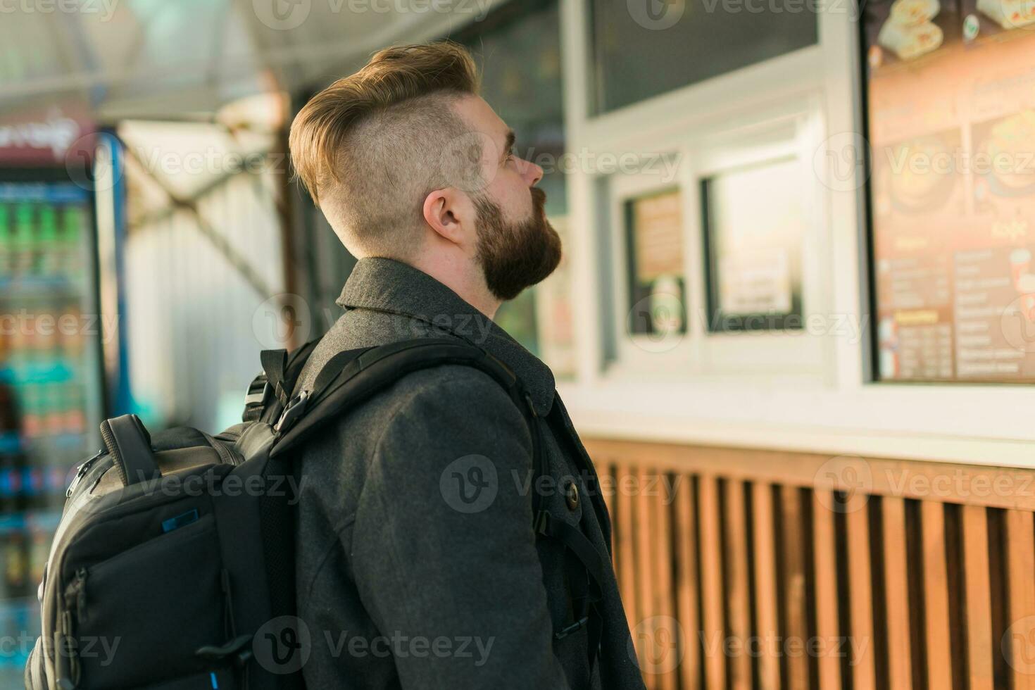 Portrait of man choosing fast food in food truck in the street. Meal, food industry and streetfood concept. photo