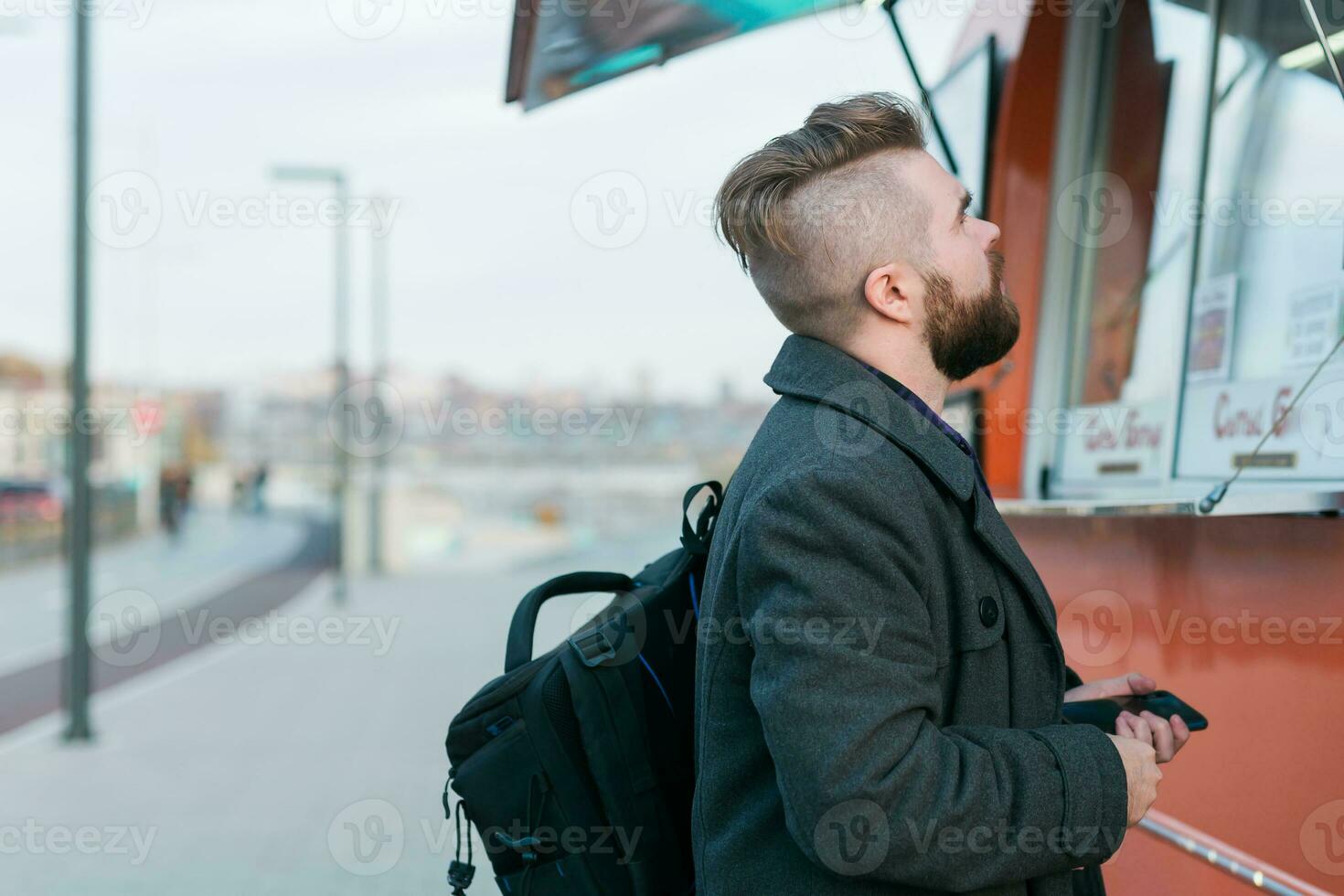 Portrait of man choosing fast food in food truck in the street. Meal, food industry and streetfood concept. photo