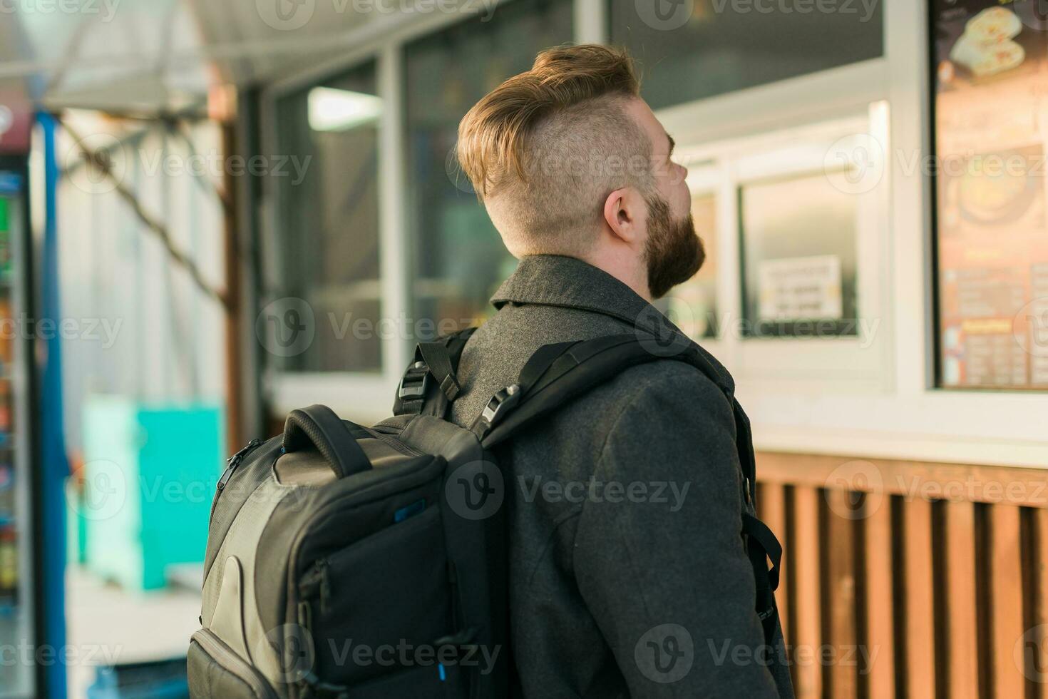 Portrait of man choosing fast food in food truck in the street. Meal, food industry and streetfood concept. photo