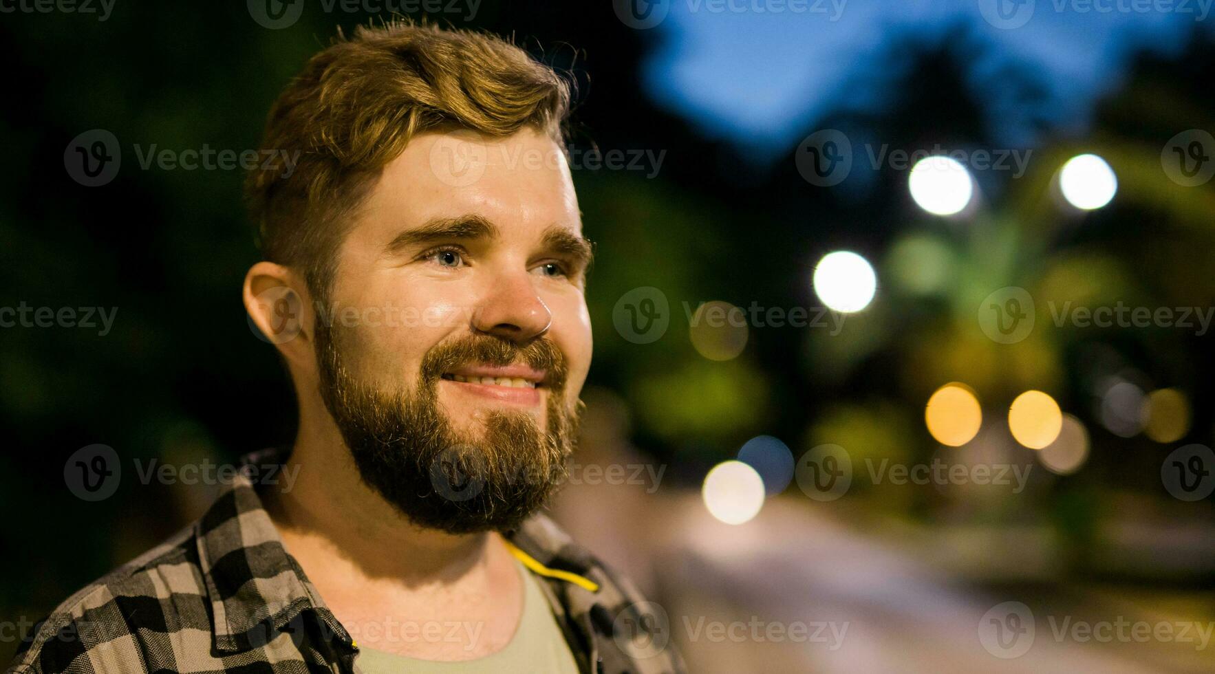 Banner portrait of man standing in night city street with copy space and place for text. Confident happy guy. Close-up portrait photo