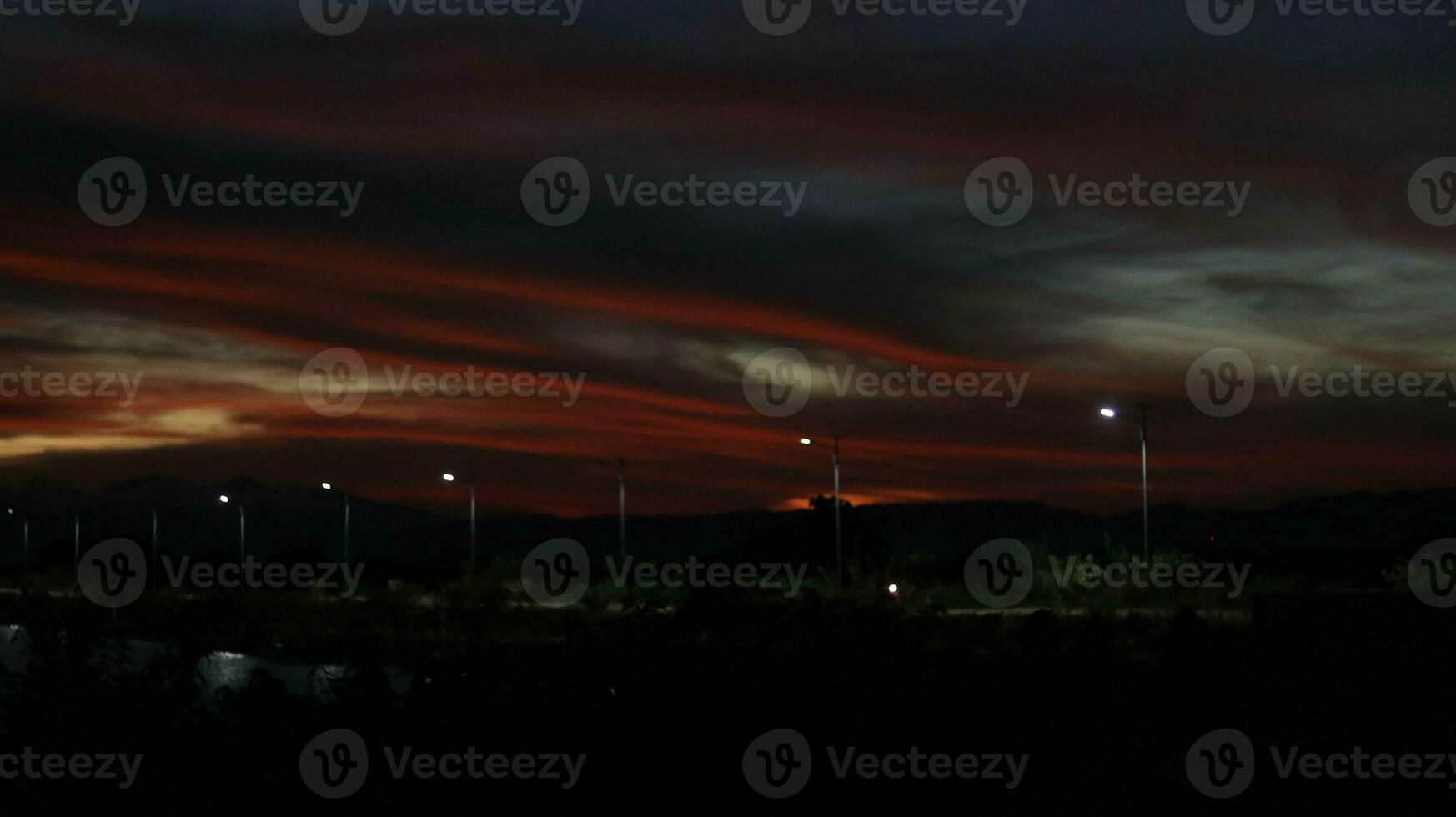 colorful dramatic sky with clouds at sunset. Sunset in  the lake photo