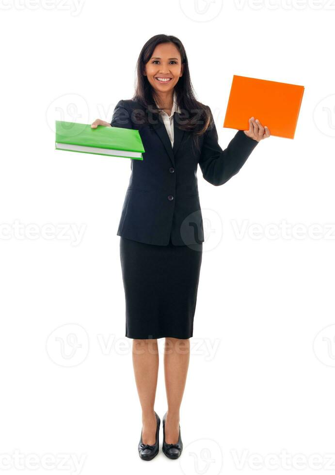 Smiling asian modern business woman holding two books and looking at camera, full length portrait isolated on white background. photo