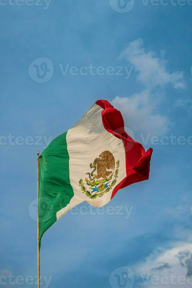 The Mexican flag soars high against the sky, symbolizing national pride during the event. photo