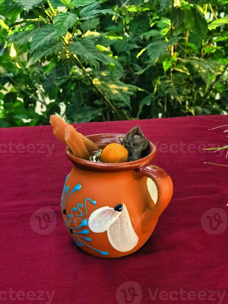 Savor the flavors of Mexico with a warm and aromatic tejocote ponche, served in exquisite dishware photo