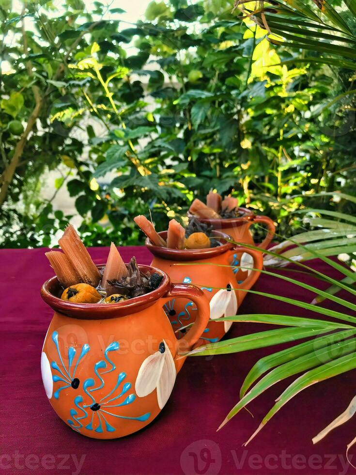 Savor the flavors of Mexico with a warm and aromatic tejocote ponche, served in exquisite dishware photo