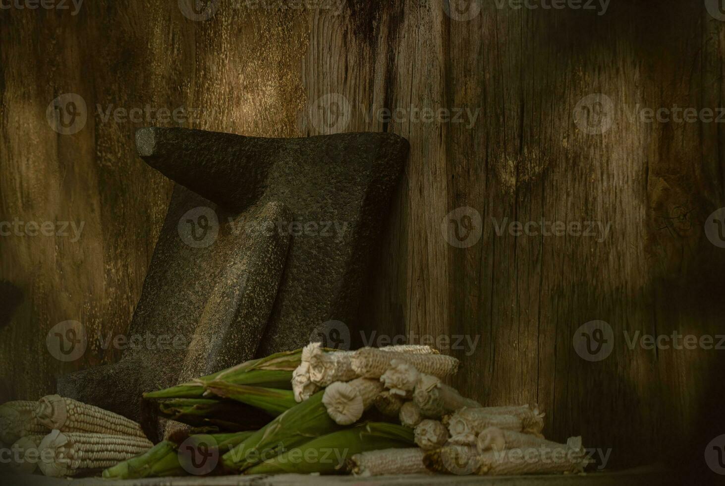 In the rustic kitchen, the wooden metate grinds corn, creating food and artistry photo