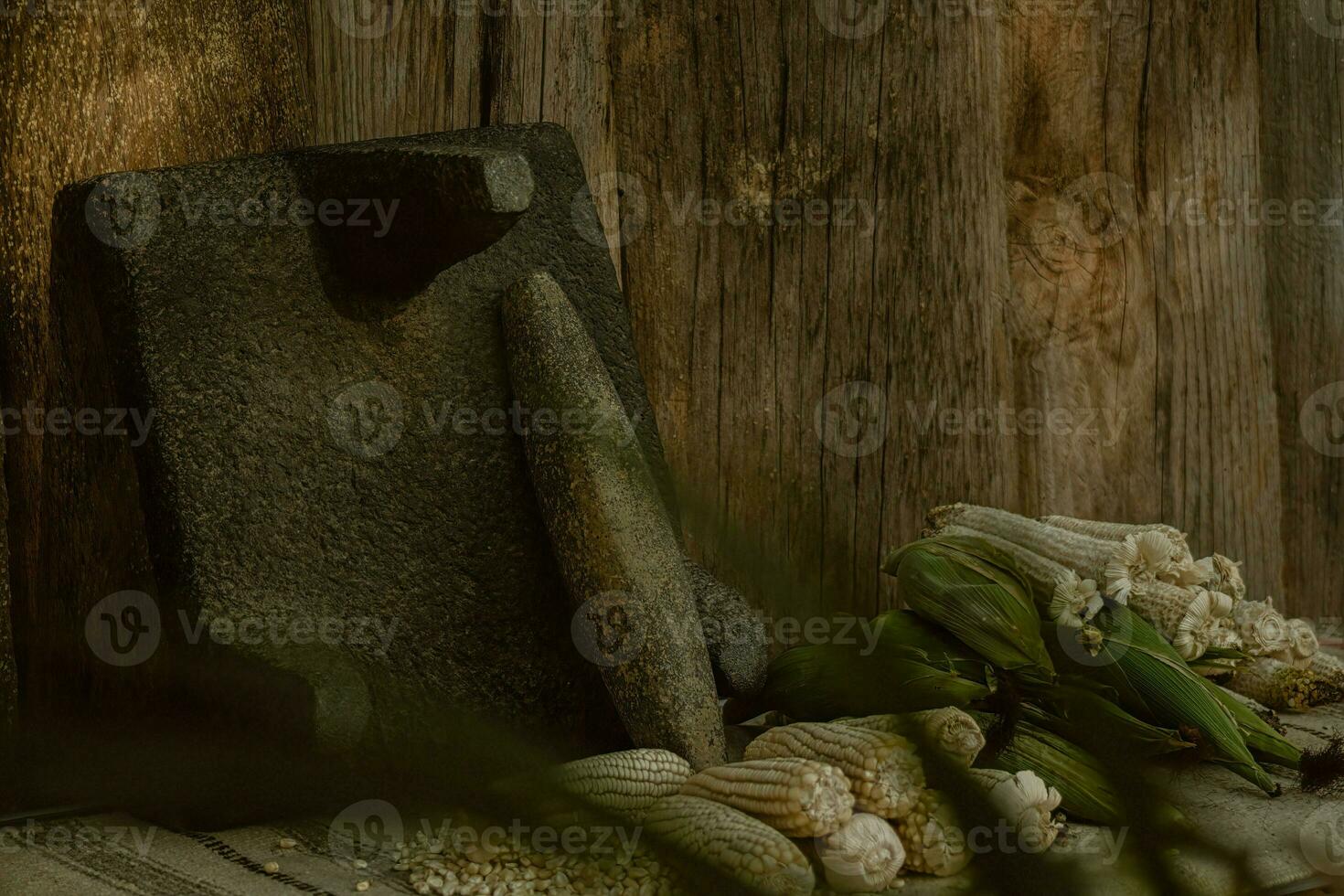 In the rustic kitchen, the wooden metate grinds corn, creating food and artistry photo