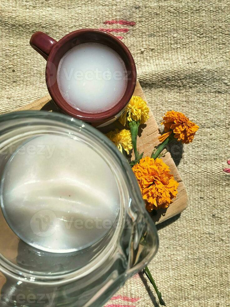 Experience the authentic taste of Mexico with pulque, a traditional maguey drink, served in beautiful dishware photo