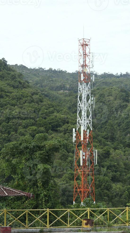 Communication Building Antenna with a backdrop of mountains and sky photo