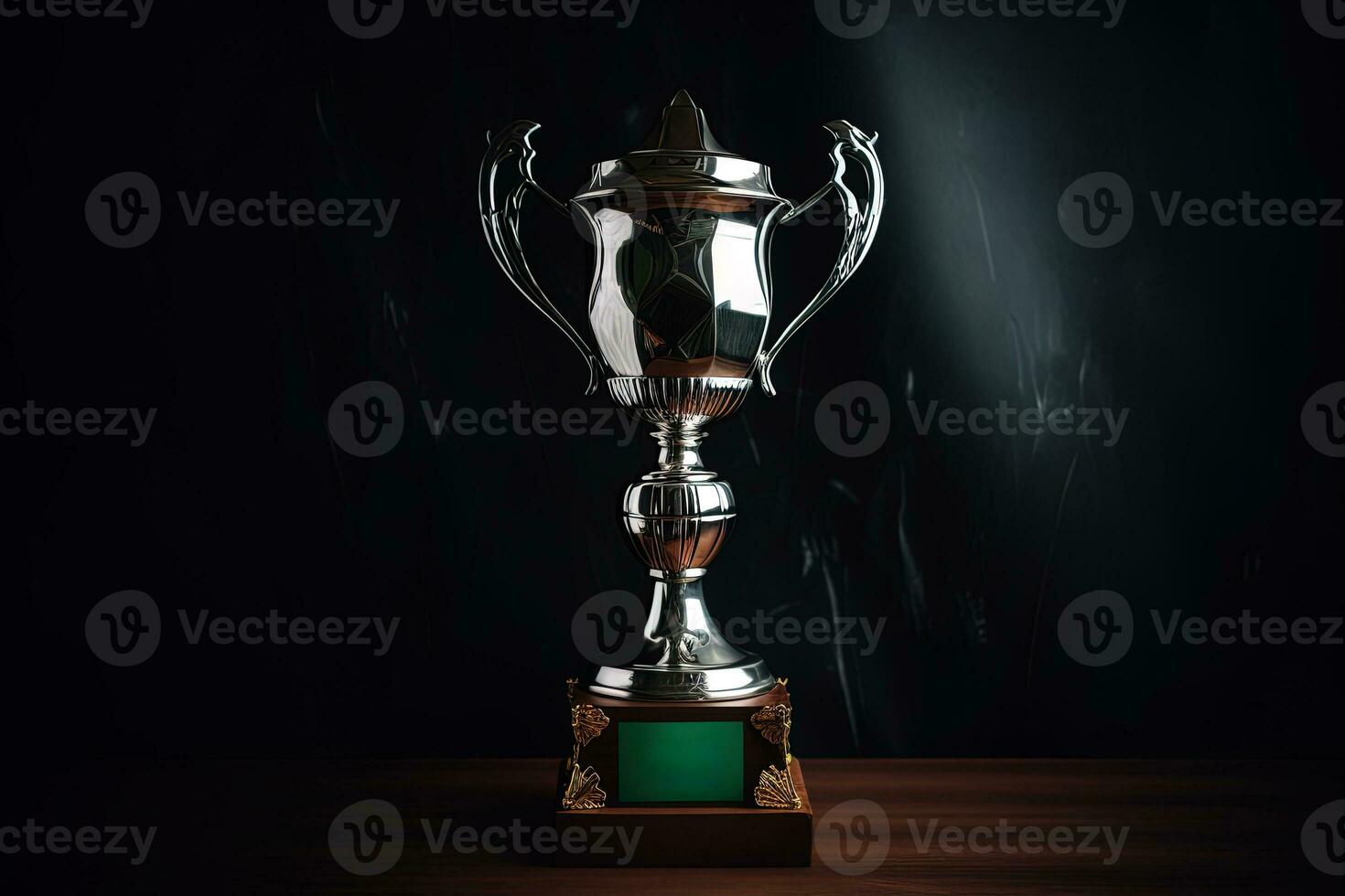 Silver glowing trophy cup on dark background. Concept of success and achievement photo