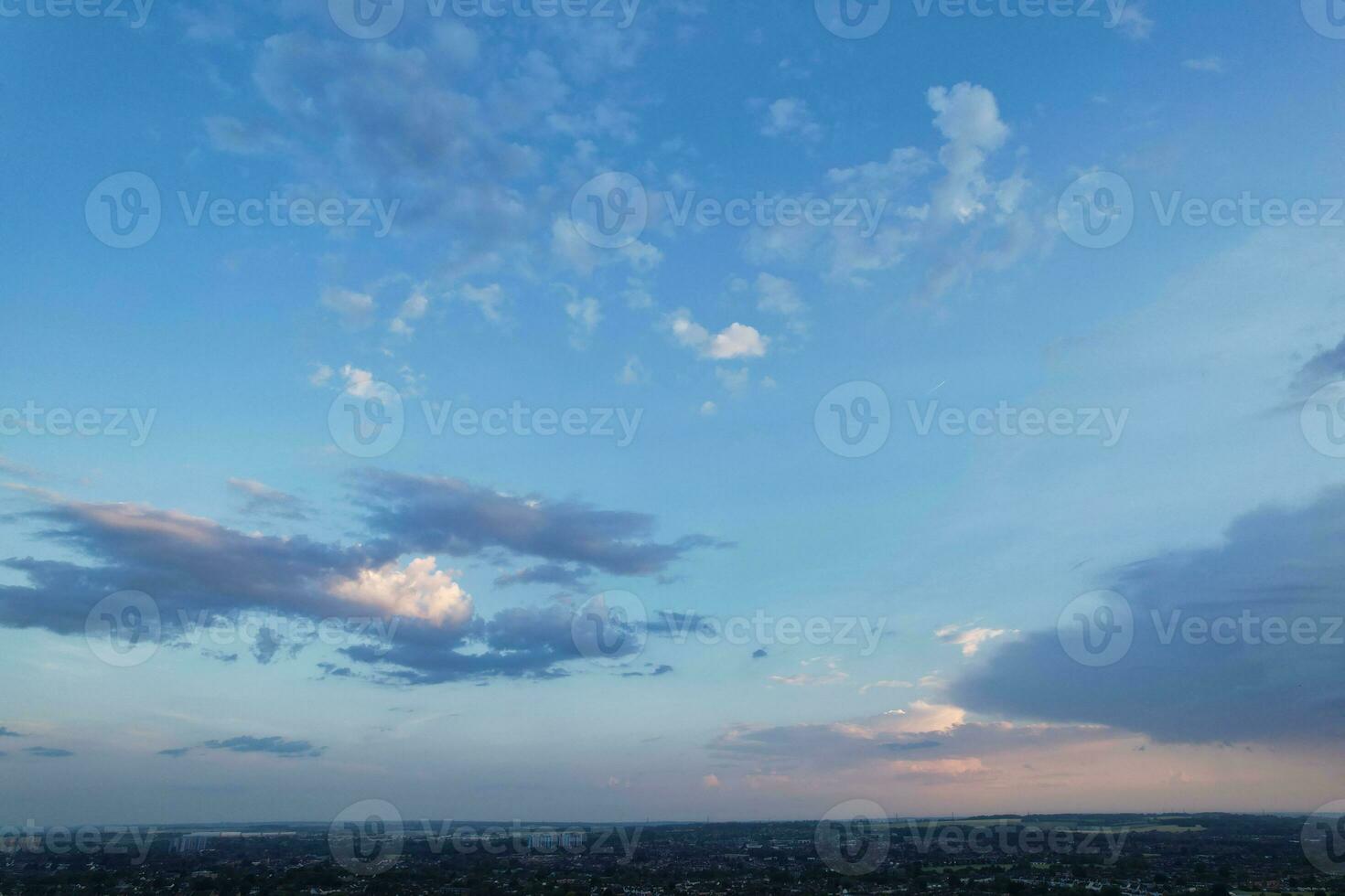 High Angle View of Luton City of England During Sunrise with Dramatical Clouds over Blue Sky. Image Was Captured with Drone's Camera on July 8th, 2023 photo