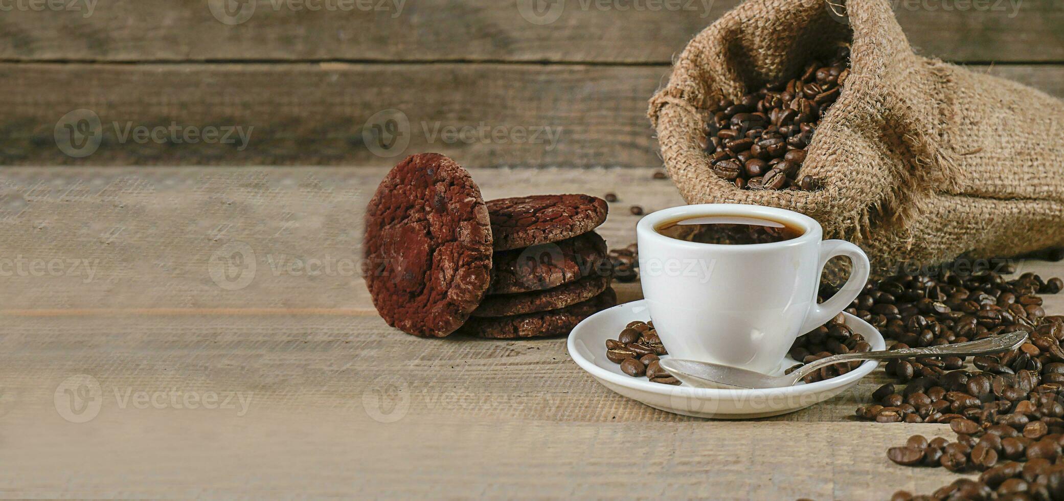 Fresh coffee. A cup of fresh aromatic coffee. Coffee cookies. Grains on a wooden background. Copy space. Banner photo