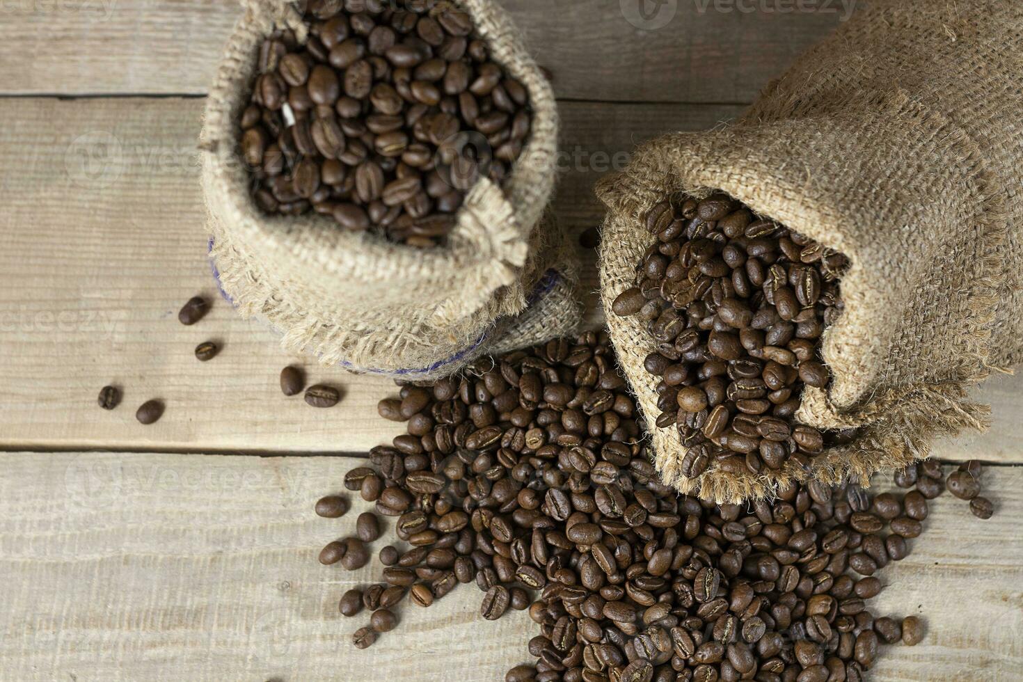 Fresh coffee. Coffee beans in bags on a wooden background. View from above. Copy space. Banner photo