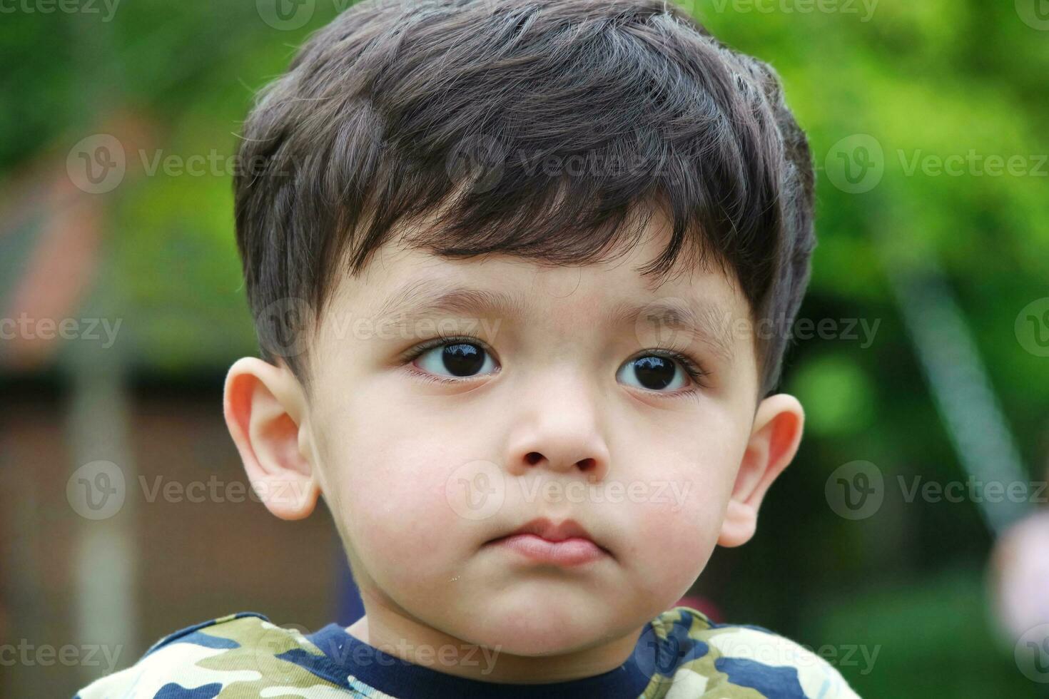 Cute Asian Pakistani Baby is Enjoying The Beautiful Sunny Day at Wardown Children and Public Park of Luton Town of England UK. Low Angle  Image Was Captured on April 03rd, 2023 photo