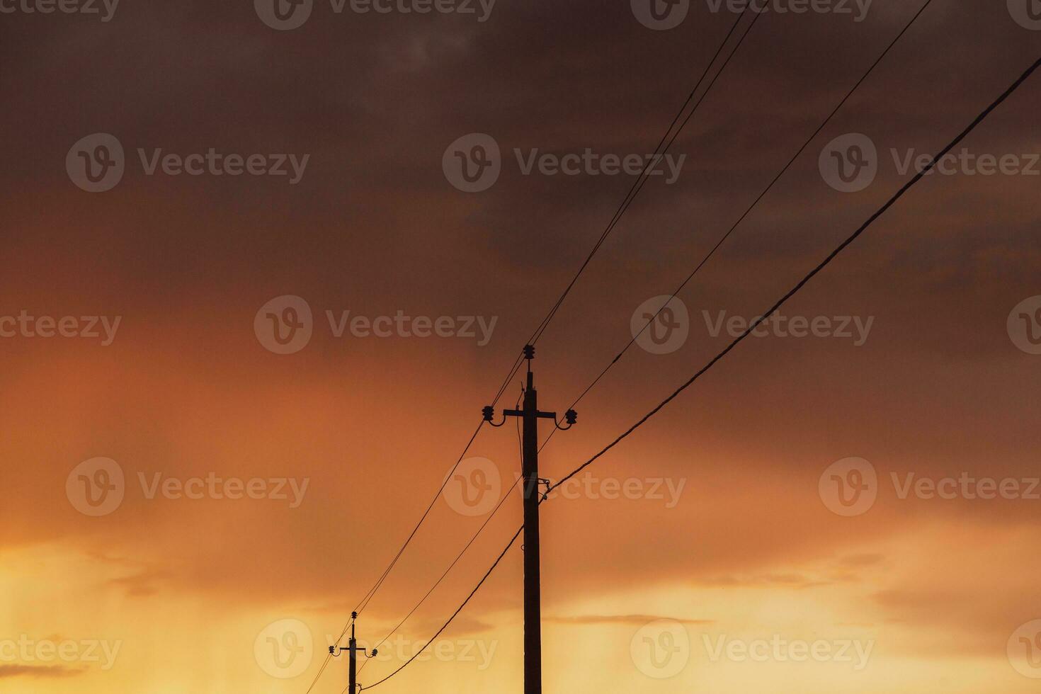 High-voltage power lines at sunset. Electricity distribution station.  electricity pylons on the background of the sky photo