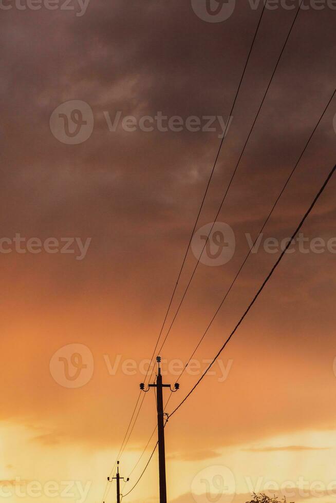 High-voltage power lines at sunset. Electricity distribution station.  electricity pylons on the background of the sky photo