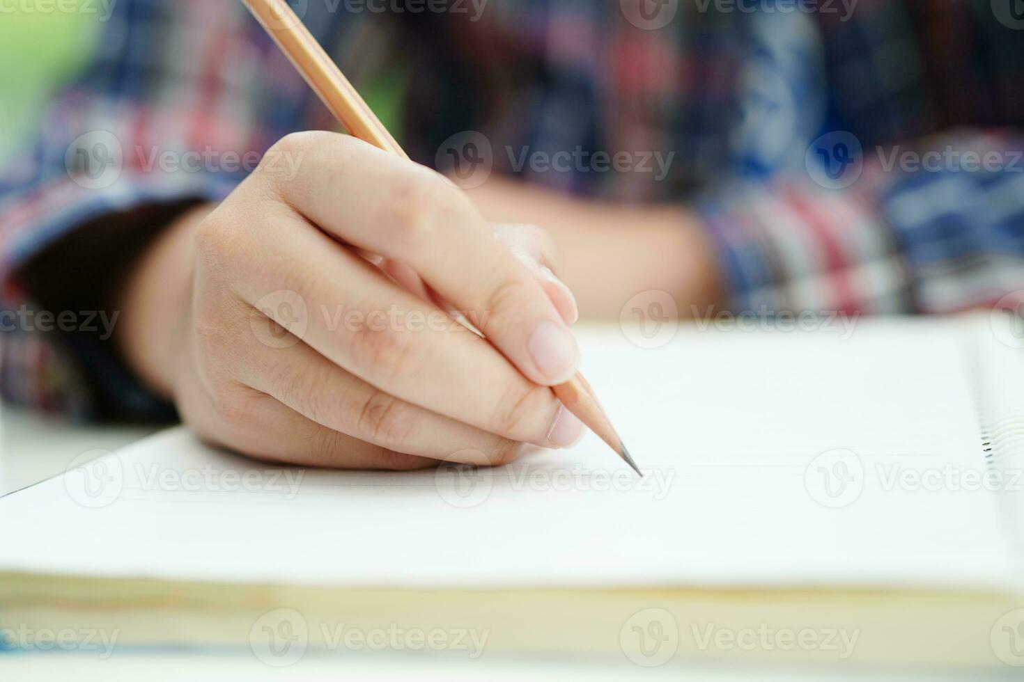 Asian teenage student write homework, study lesson for exam online learning education. photo