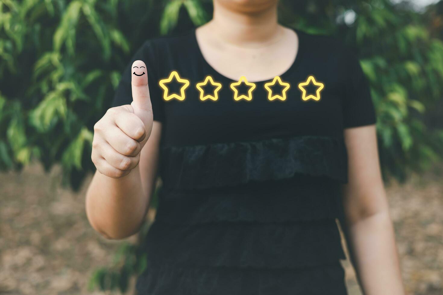 a woman thumbs up on the happy Smiley face icon and five star to give satisfaction in service.rating very impressed.Customer service and Satisfaction concept photo
