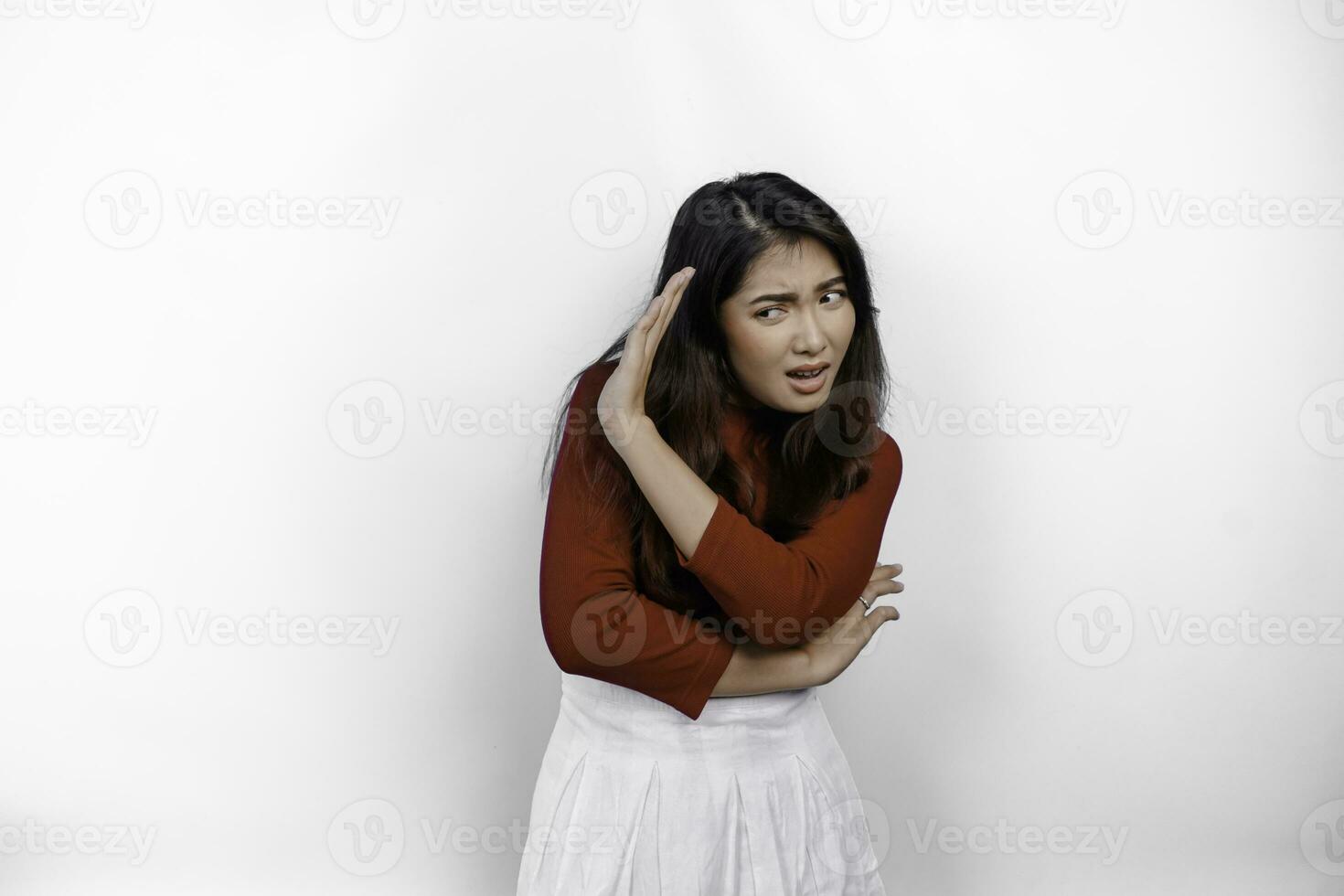 Attractive Asian woman wearing red t-shirt with hand gesture pose rejection or prohibition isolated by white background photo